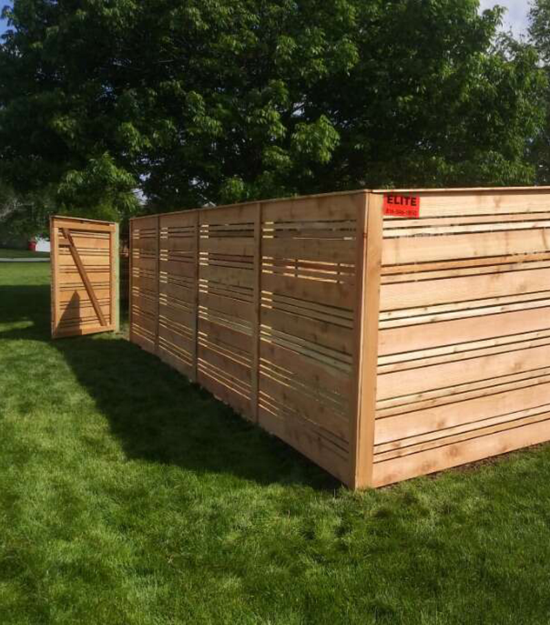 New wood fence featuring a contemporary horizontal slat design built by Elite Fence.
