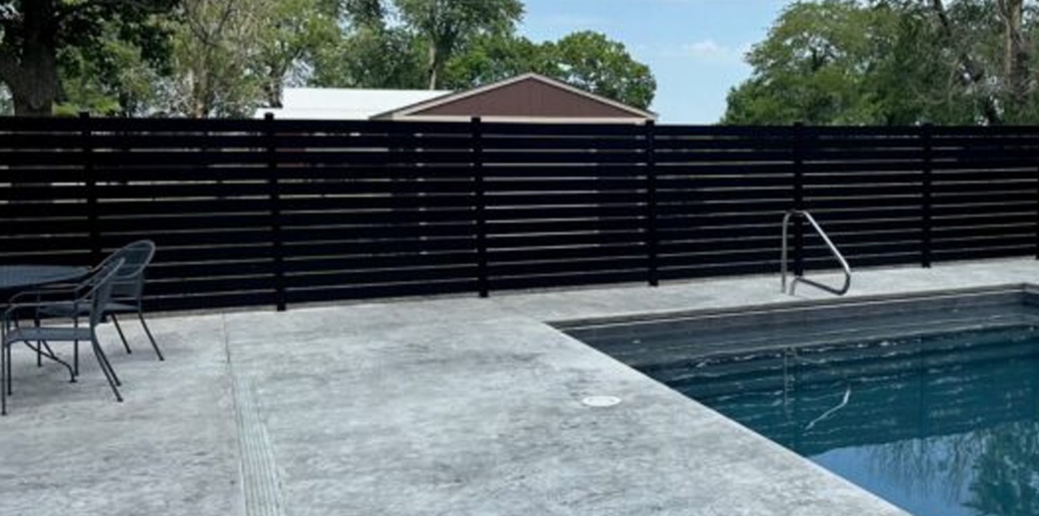 Elite Fence installation of a black Centurion Select Aluminum horizontal slat fence providing pool privacy and safety.