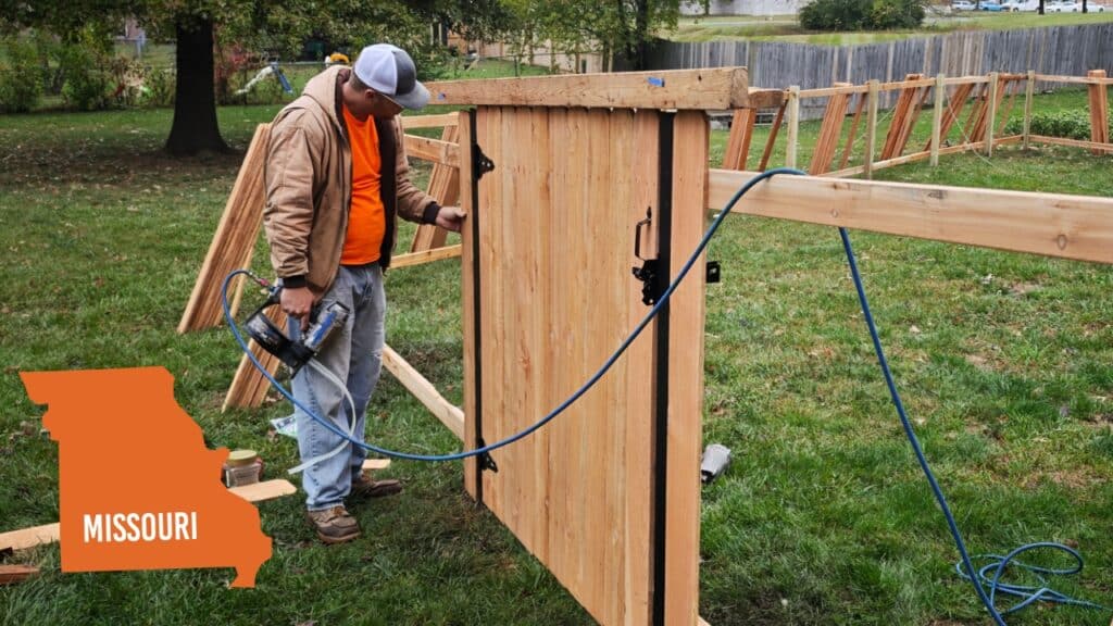 Professional contractor building a wood fence in Missouri; expert installation ensures local permit compliance and structural longevity.
