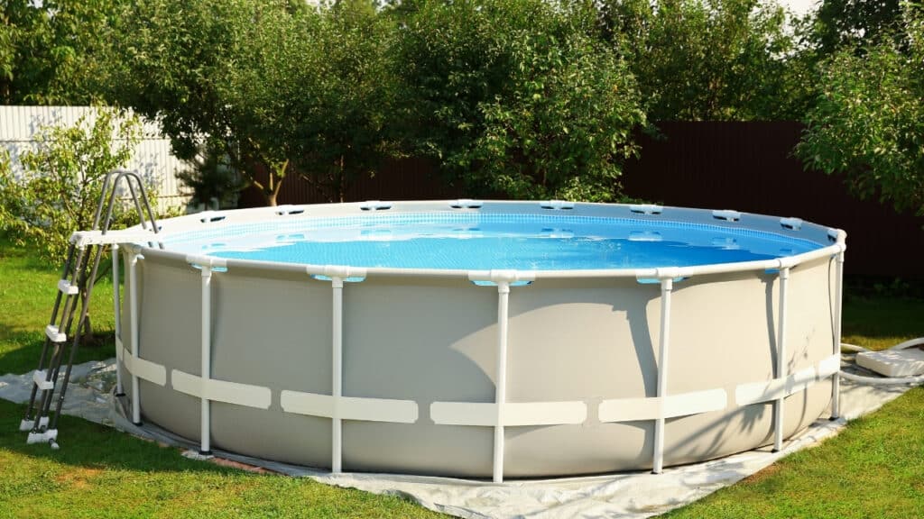 Safety fence installed around an above-ground pool with a wooden deck, highlighting backyard pool safety and local code compliance.